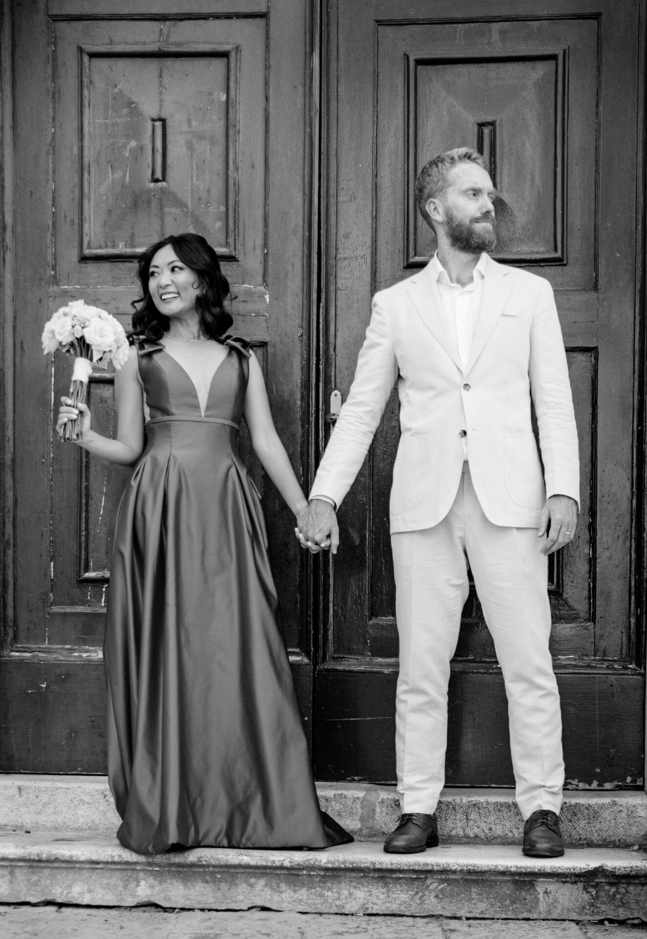 newlyweds standing in front of church